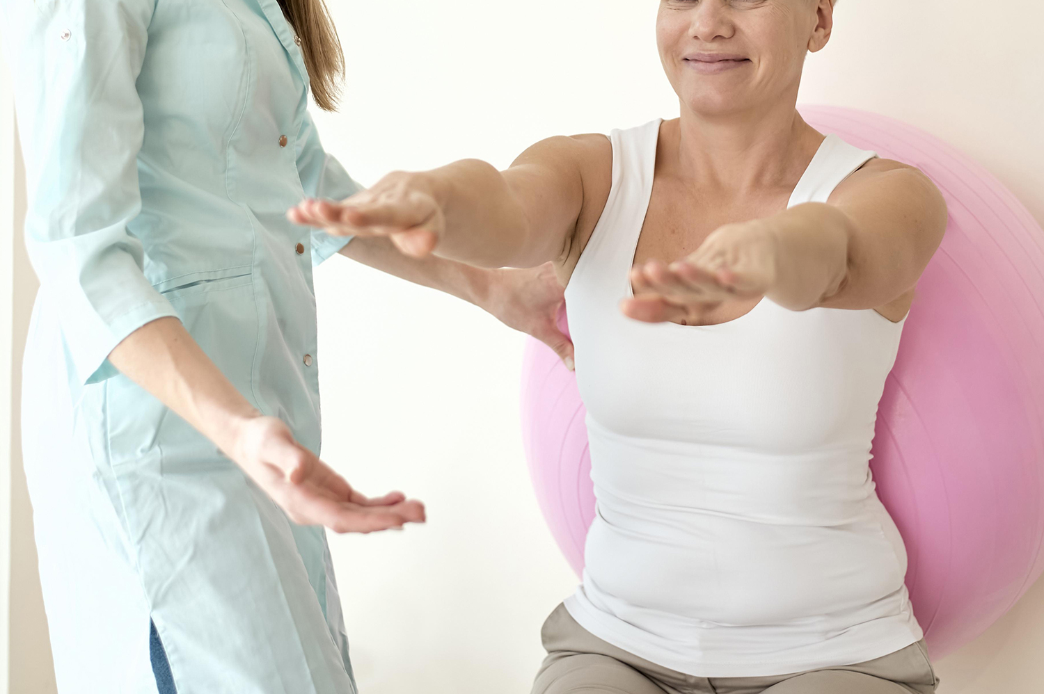 professional female physiotherapist giving shoulder massage to blonde woman