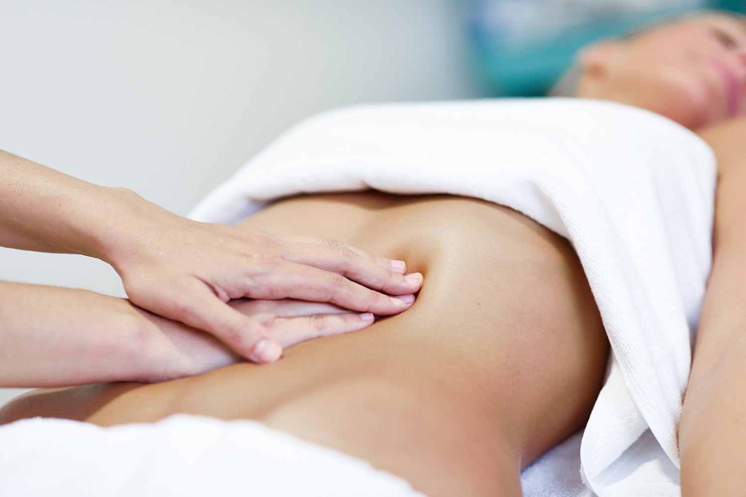 professional female physiotherapist giving shoulder massage to blonde woman